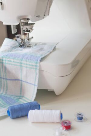 Sewing machine part, fabric, threads and accessories for sewing close-upの写真素材