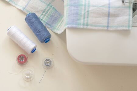 Sewing machine part, fabric, threads and accessories for sewing close-up.の写真素材