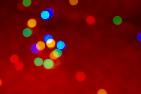 Defocus multicolored lights. Red bokeh background. Abstract christmas textureの写真素材