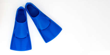 Blue flippers on a white background. Baner Flat lay. Copy spaceの写真素材