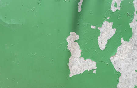 Wall of a building with peeling old paint. Green abstract background. Copy spaceの写真素材