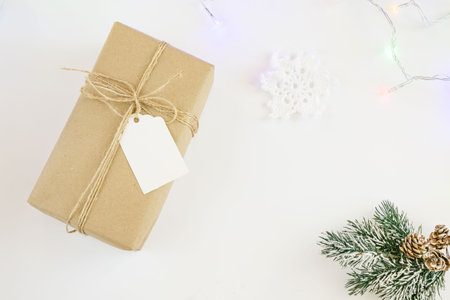 Vintage craft gift with rope and blank label isolated on white background. Top view, copy spaceの写真素材