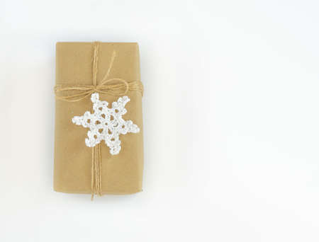 Christmas and New Years flatlay background. Gift box wrapped in kraft paper with jute cord....