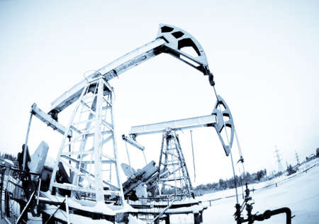 two oil pump on the field, frosty winter day. selenium tone.の写真素材