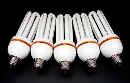 Compact fluorescent light bulbs isolated on black background の写真素材