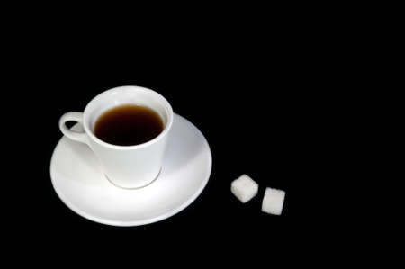 cup of coffee and sugar isolated on a black backgroundの写真素材