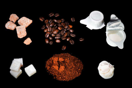 coffee ingredient, beans, cube sugar, cream isolated on a black backgroundの写真素材