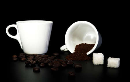  white cups, coffee beans,  sugar cubes on a black backgroundの写真素材