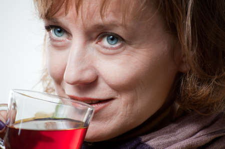 portrait of a blue-eyed woman with a cup  teaの写真素材