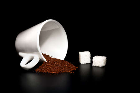 white cup, coffee powder, sugar cubes on a black backgroundの写真素材