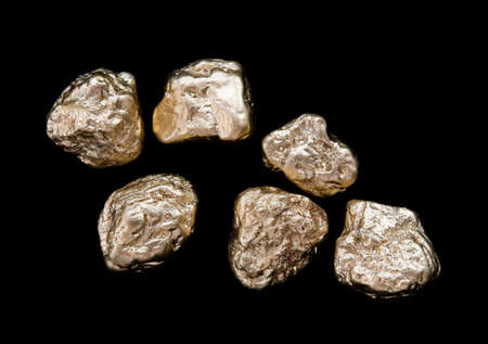 gold nuggets on a black background. closeup.の写真素材