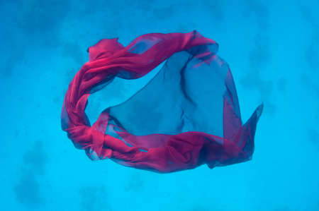 Abstract image of red fabric underwater backgroundの写真素材