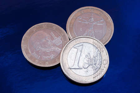 three euro coins on a blue background. closeup.の写真素材