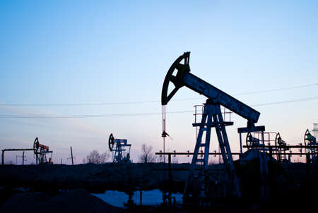 The oil pump on a background of the sunset sky の写真素材