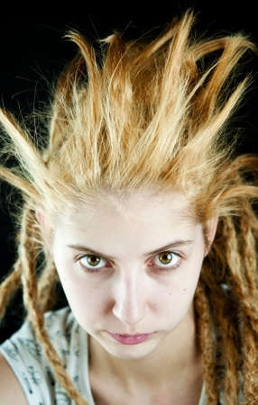 young girl with a strange hairdo on a black backgroundの写真素材