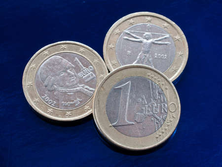 three euro coins on a blue background. closeup.の写真素材