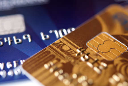 two credit cards, blue and gold, narrow focus. closeup.の写真素材