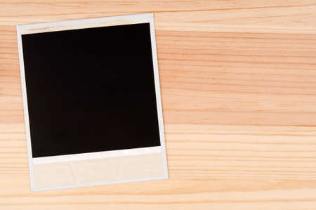 old photo frame on a wooden backgroundの写真素材