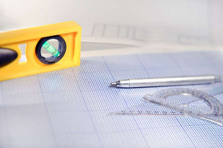 Pencil, graph paper, water level and ruler. Workplace Designer. Shot with shallow depth of field. Selective focus.の写真素材