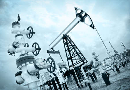 Extraction of oil. Pump jack and oil wellhead. Toned.のeditorial素材