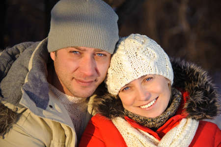 Portrait of woman and her boyfriend in the winter park.