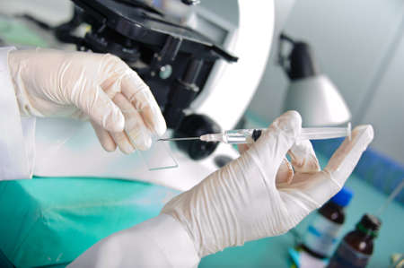 Medical laboratory research tools in the hands in gloves.の写真素材