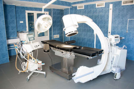 operating room with X-ray medical scan and equipment for artificial lung ventilation of patient.のeditorial素材