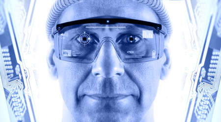 Portrait of men in smart glasses on a electronic circuit board background  Toned blue 