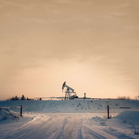 Pump jack on a sky background. Toned. Square format.の写真素材
