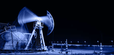 Oil and gas industry. Panoramic of a pumpjack. Night view.の写真素材