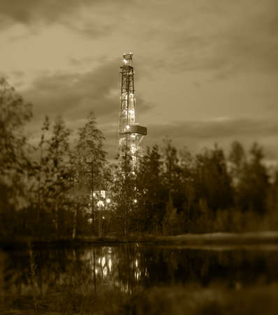 Night landscape with the drilling rig. Selective focus, shallow depth of field.の写真素材
