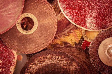 Closeup various abrasive discs, hacksaw and circular saw blades pattern. Toned.の写真素材