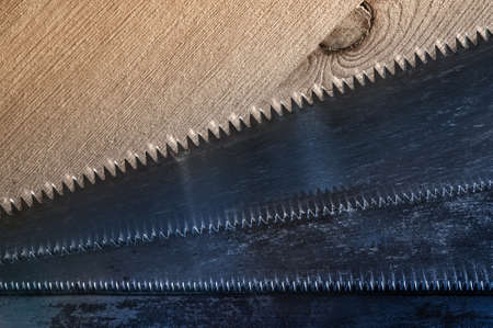 Old saws blade on the wooden background. Toned.の写真素材