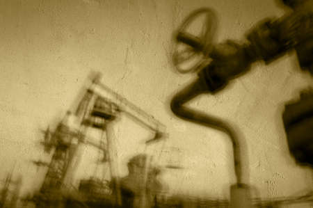 Work of oil pump jack on a oil field. Textured concrete grunge, blurred motion.  Concept oil and gas industry.の写真素材