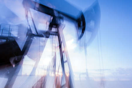 Work of oil pump jack on a oil field. Double long exposure, blurred motion.  Concept oil and gas industry.の写真素材