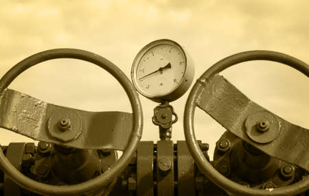 Industrial wellhead with valve armature. Oil, gas theme. Toned sepia.の写真素材