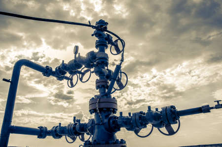 Horizontal view of a wellhead with valve armature. Oil and gas industry concept. Industrial site...