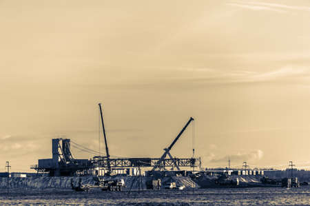 Works for the installation of the rig in the oilfield. Cranes, vehicle and derrick. Oil and gas theme.の写真素材
