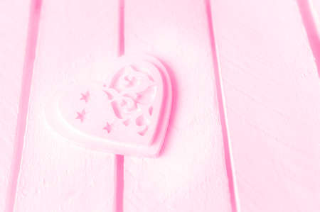 Pink heart on a white wood background.の写真素材