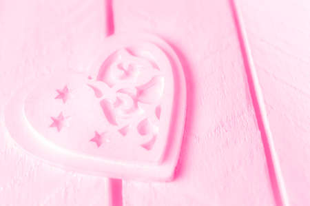 Pink heart on a white wood background.の写真素材