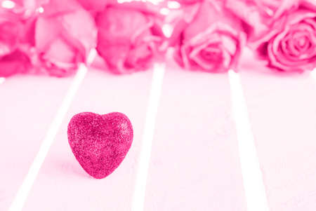 Pink hearts and rose on white wood background.の写真素材
