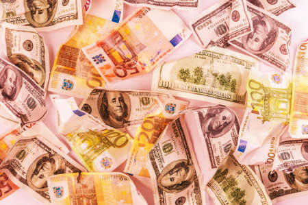 Fake dollars and euro crumpled money backgroundの写真素材
