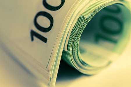 Money, Euro cash background. Banknotes of the european union on a white background. 100 euros roll.の写真素材