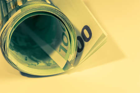 Money, Euro cash background. Banknotes of the european union on a white background. 100 euros roll.の写真素材