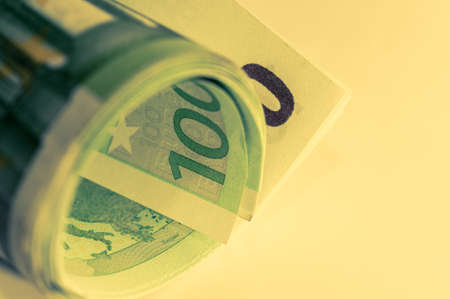 Money, Euro cash background. Banknotes of the european union on a white background. 100 euros roll.の写真素材