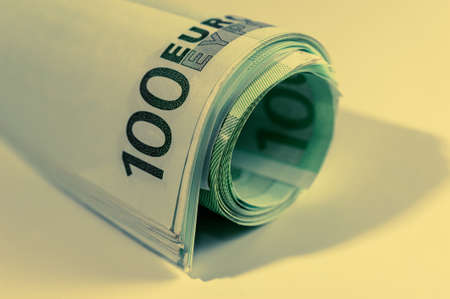 Euro money, Euro cash background. Banknotes of the european union on a white background. Close up. 100 euros roll.の写真素材