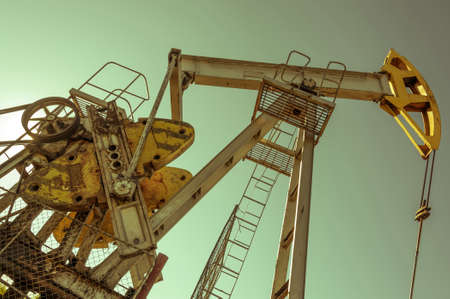 Oil pumpjack, industrial equipment. Rocking machines for power genertion. Extraction of oil. Petroleum concept.の写真素材