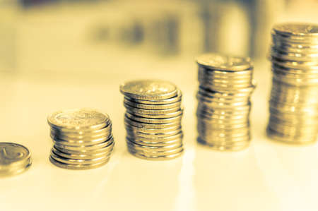 Stack of coins macro. Rows of coins for finance and banking concept. Economy trends background for business idea.の写真素材