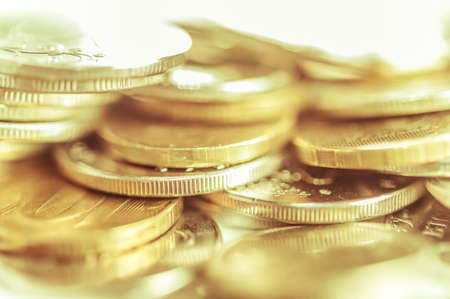 Stack of golden coins macro. Rows of coins for finance and banking concept. Economy trends background for business idea.の写真素材