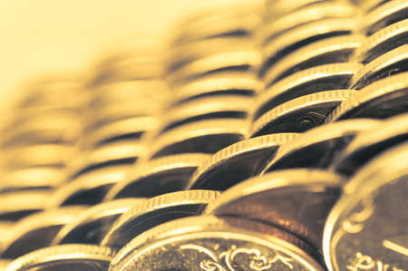 Stack of golden coins macro. Rows of coins for finance and banking concept. Economy trends background for business idea.の写真素材